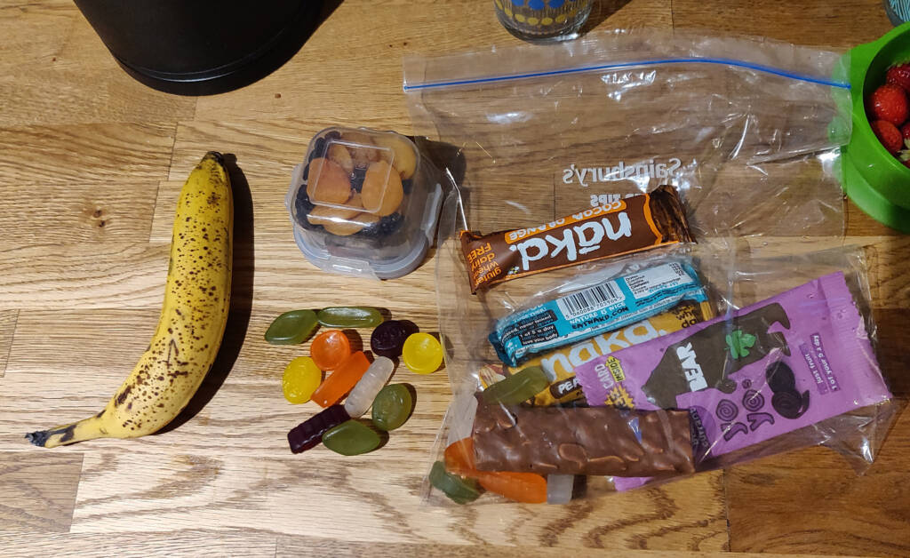 Assortment of foods being sorted out for ultra trail running preparation.
